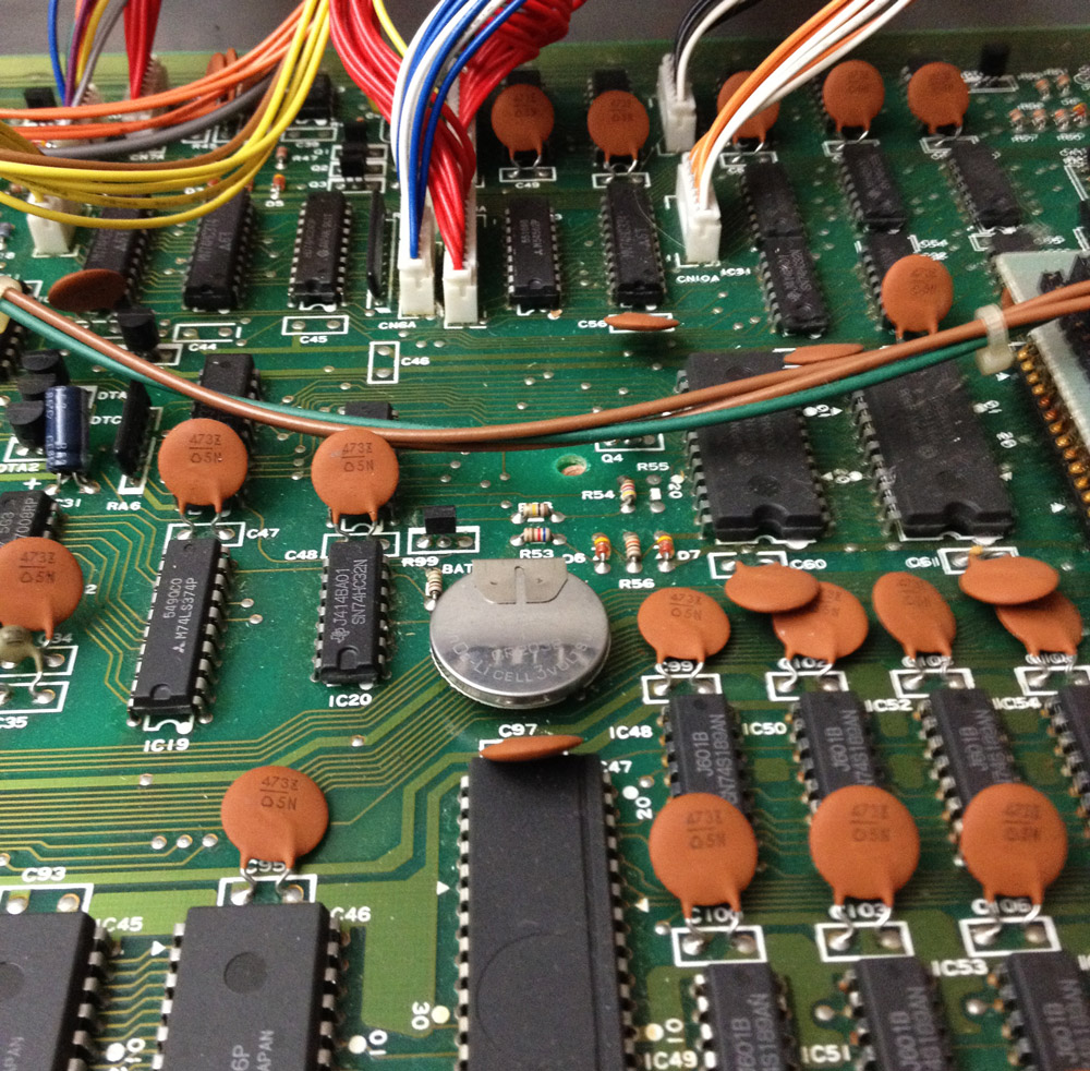 Original Korg DW-8000 backup battery soldered to the main circuit board. WHY!?